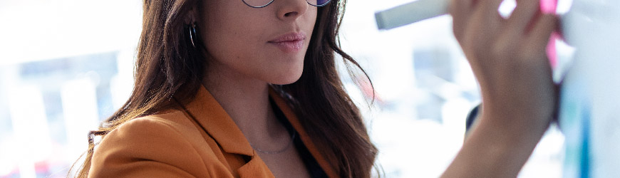 Business analyst writing on whiteboard