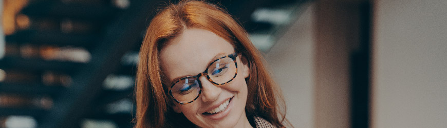 Businesswoman working on laptop and smiling