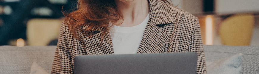 Businesswoman working on laptop and smiling