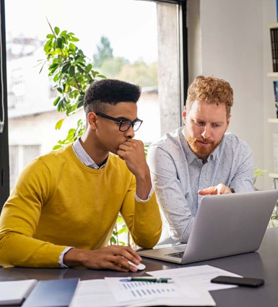 two men working on laptop