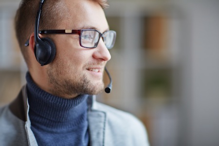 a male helpdesk agent smiling